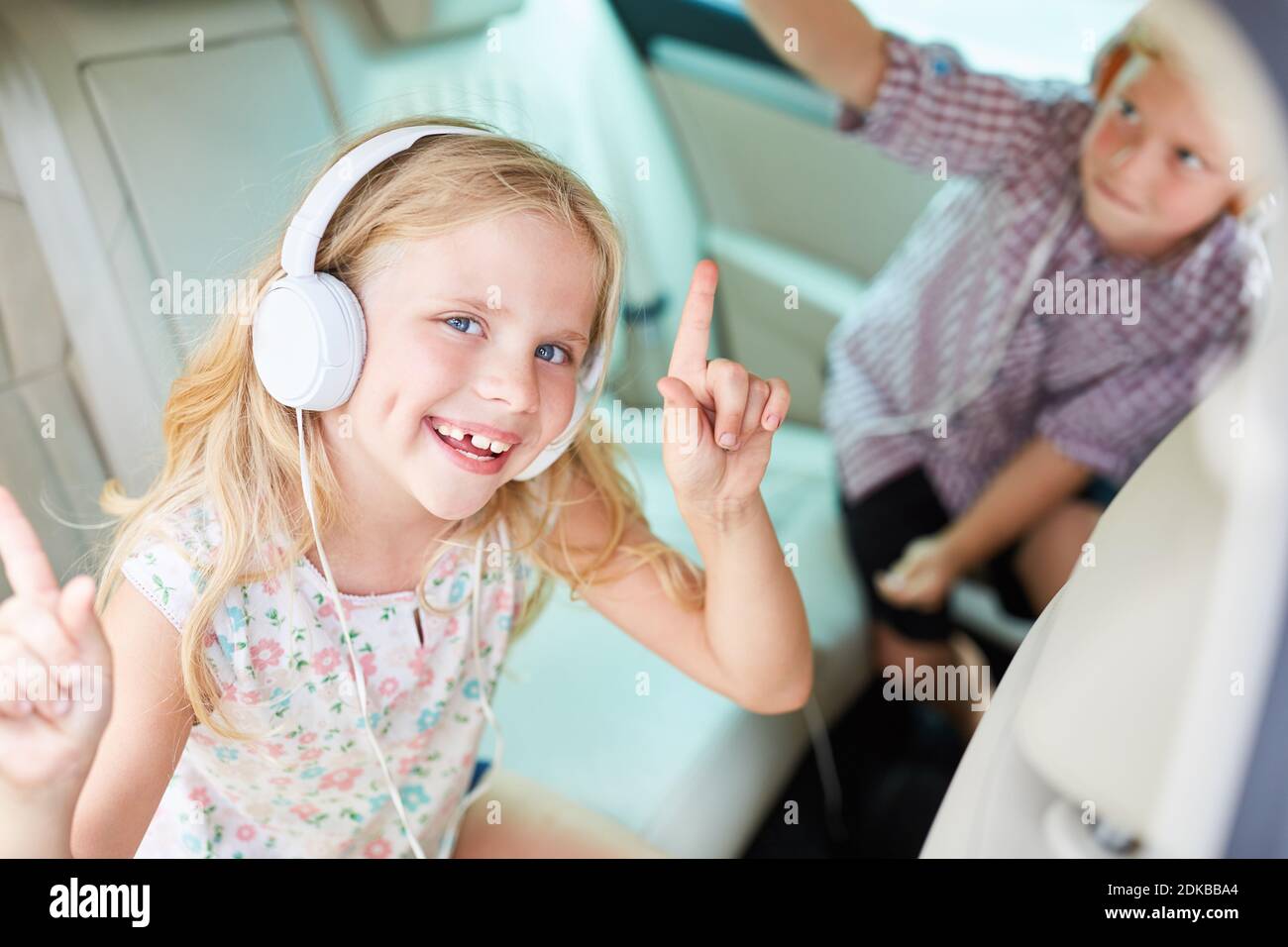 Portrait Of Smiling Cute Girl By Boy Dancing In Car Stock Photo Alamy