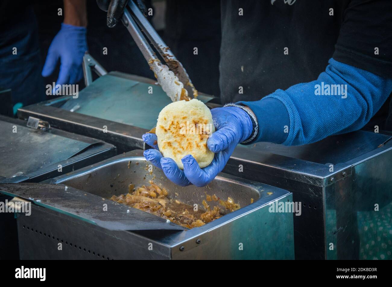 Midsection Of Man Preparing Arepa On Barbecue Grill Stock Photo