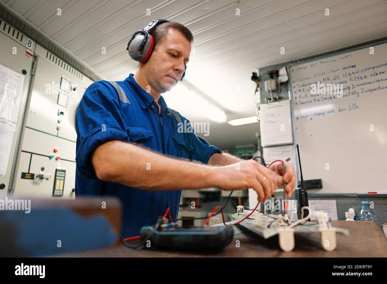 Marine electrical engineer officer in engine control room ECR. He works