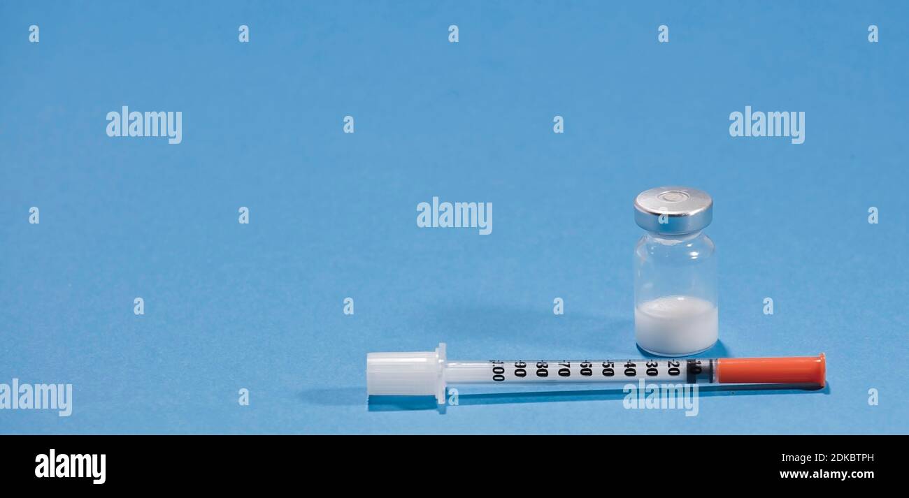 vaccine and syringe with blue background Stock Photo - Alamy