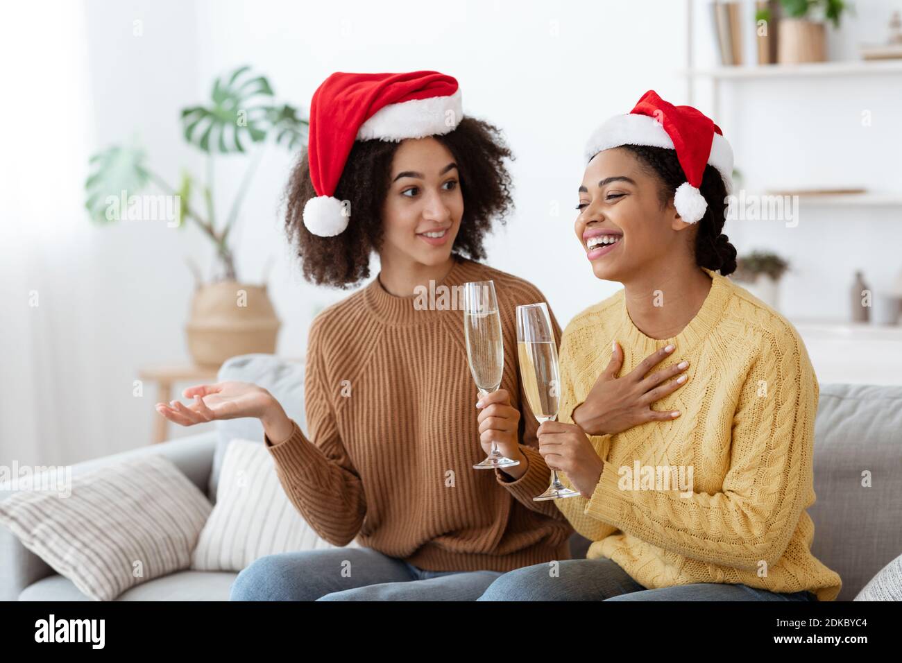 Merry Christmas and happy New Year. Cute cheerful african american young students ladies Stock Photo