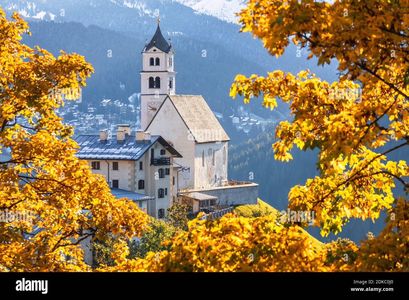 the church of Colle Santa Lucia framed by autumn foliage, Agordino, Dolomites, province of Belluno, Veneto, Italy, Europe Stock Photo