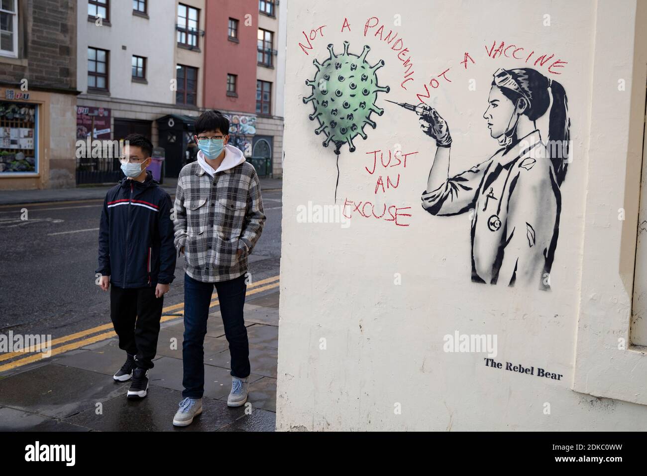 Edinburgh, Scotland, UK. 15 December 2020. Street art of Covid-19 vaccination by street artist  The Rebel Bear in Edinburgh is vandalised by anti vaccination protestor. Iain Masterton/Alamy Live News Stock Photo