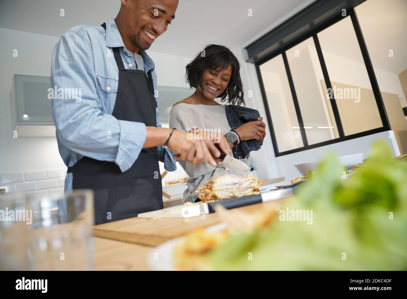 Portrait of african american couple laughing while cooking meal Stock ...