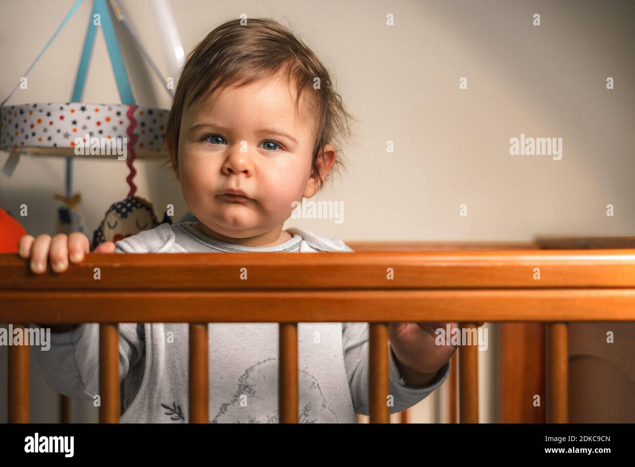 Portrait Of Cute Baby Boy In Crib Stock Photo Alamy