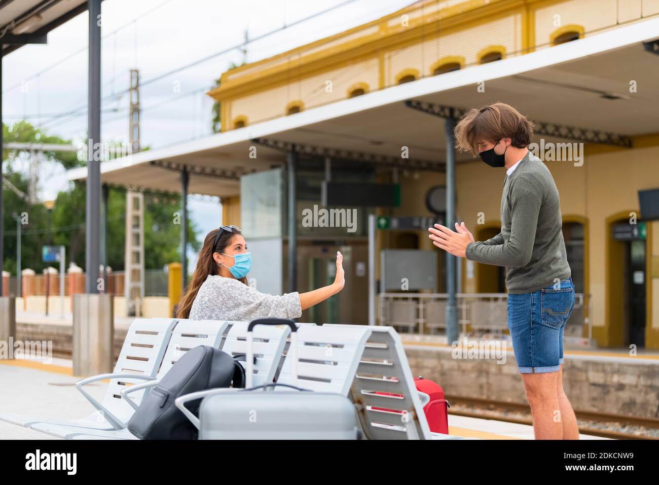 Man Talking With Woman On Railroad Station Platform Stock Photo