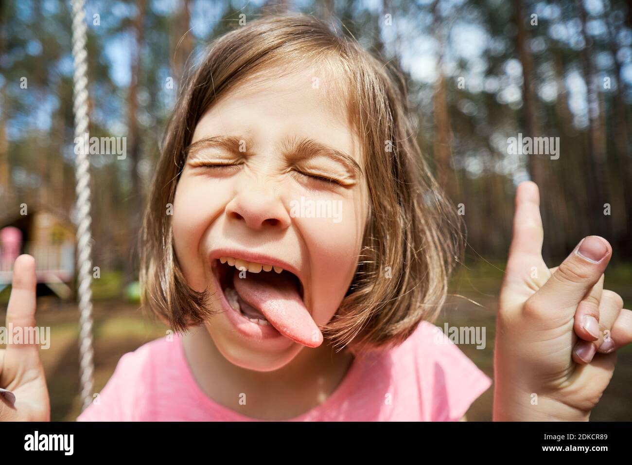 Girl closed eyes sticking out tongue hires stock photography and