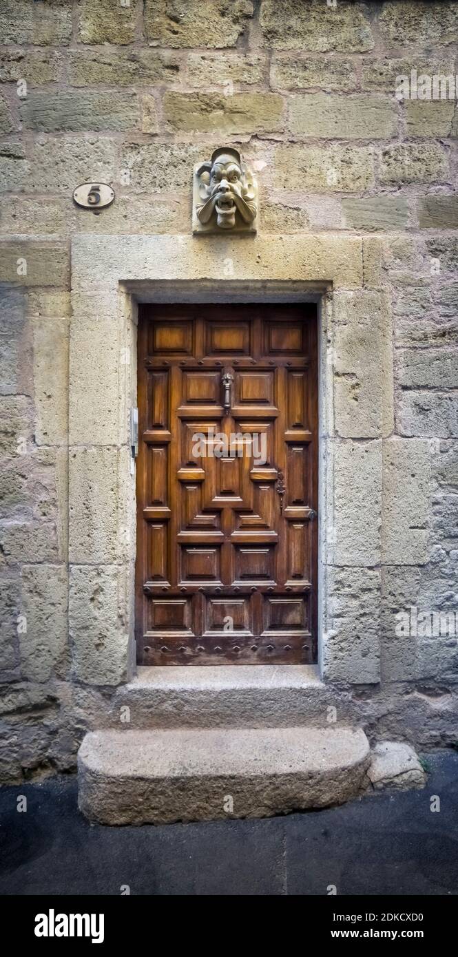 Grimace over wooden door in the Jewish ghetto in Pézenas in summer. Built around the XVI century. Stock Photo