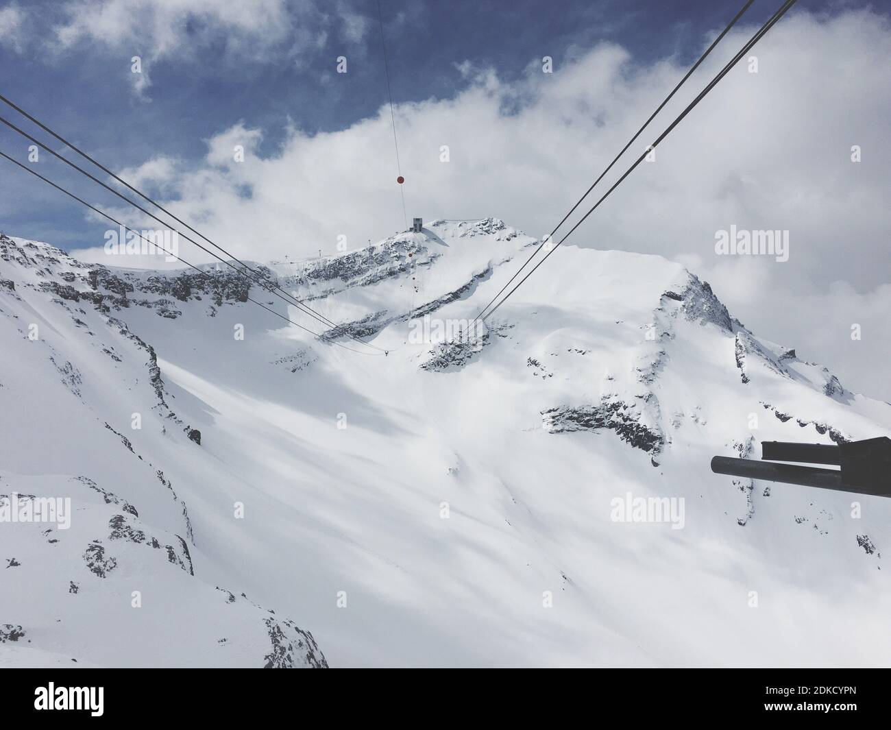 Low Angle View Of Ski Lift Over Snowcapped Mountains Against Sky Stock Photo
