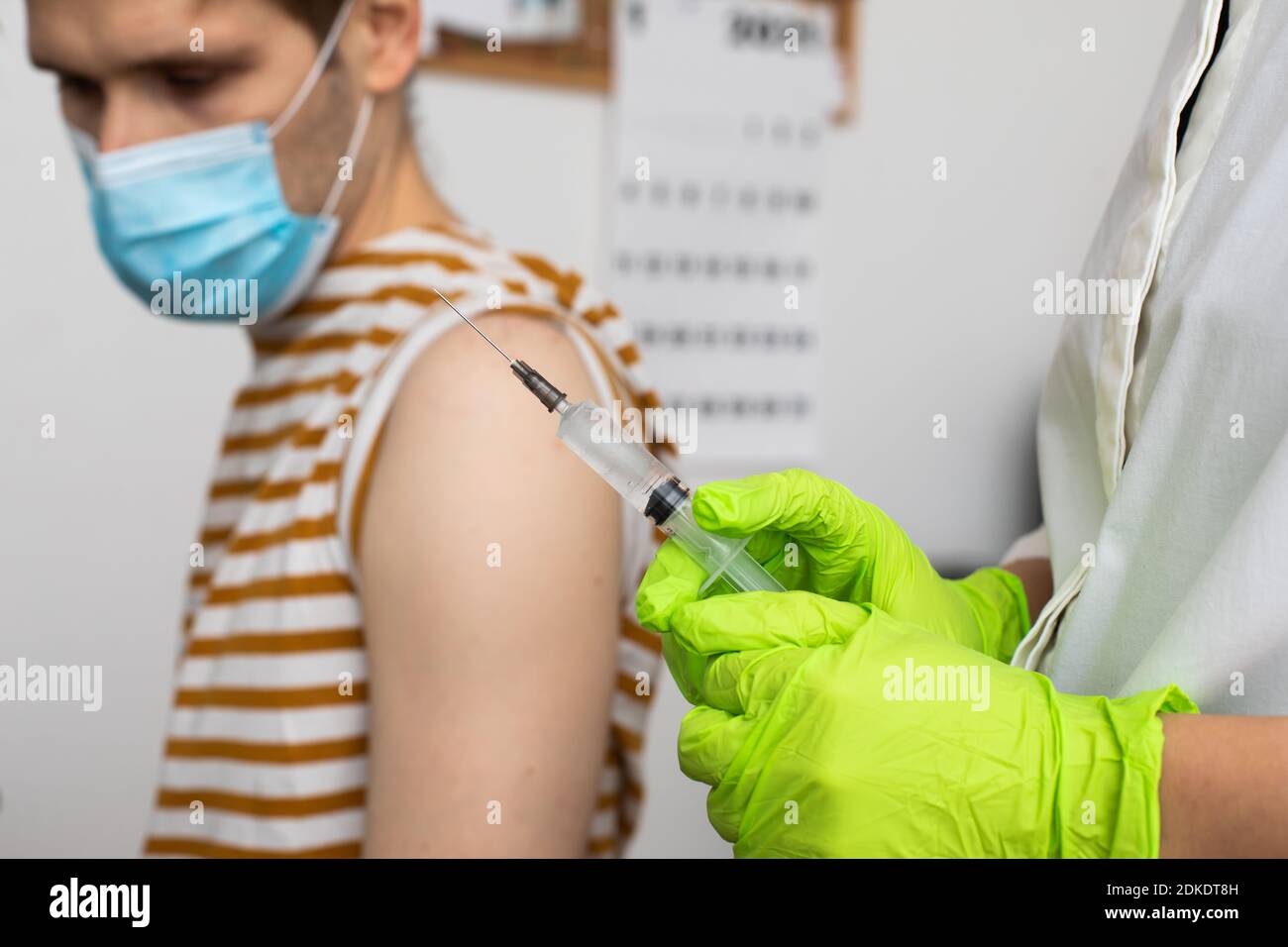 Man receives jab, male getting vaccinated. Parents gets a shot Doctors set to give first authorized doses of Covid-19 vaccine Second-Generation Stock Photo