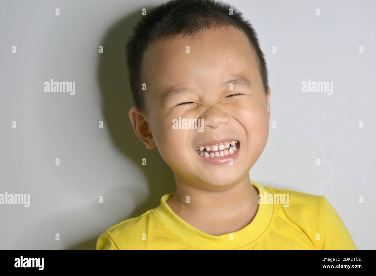 Smiling Boy Against Wall Stock Photo