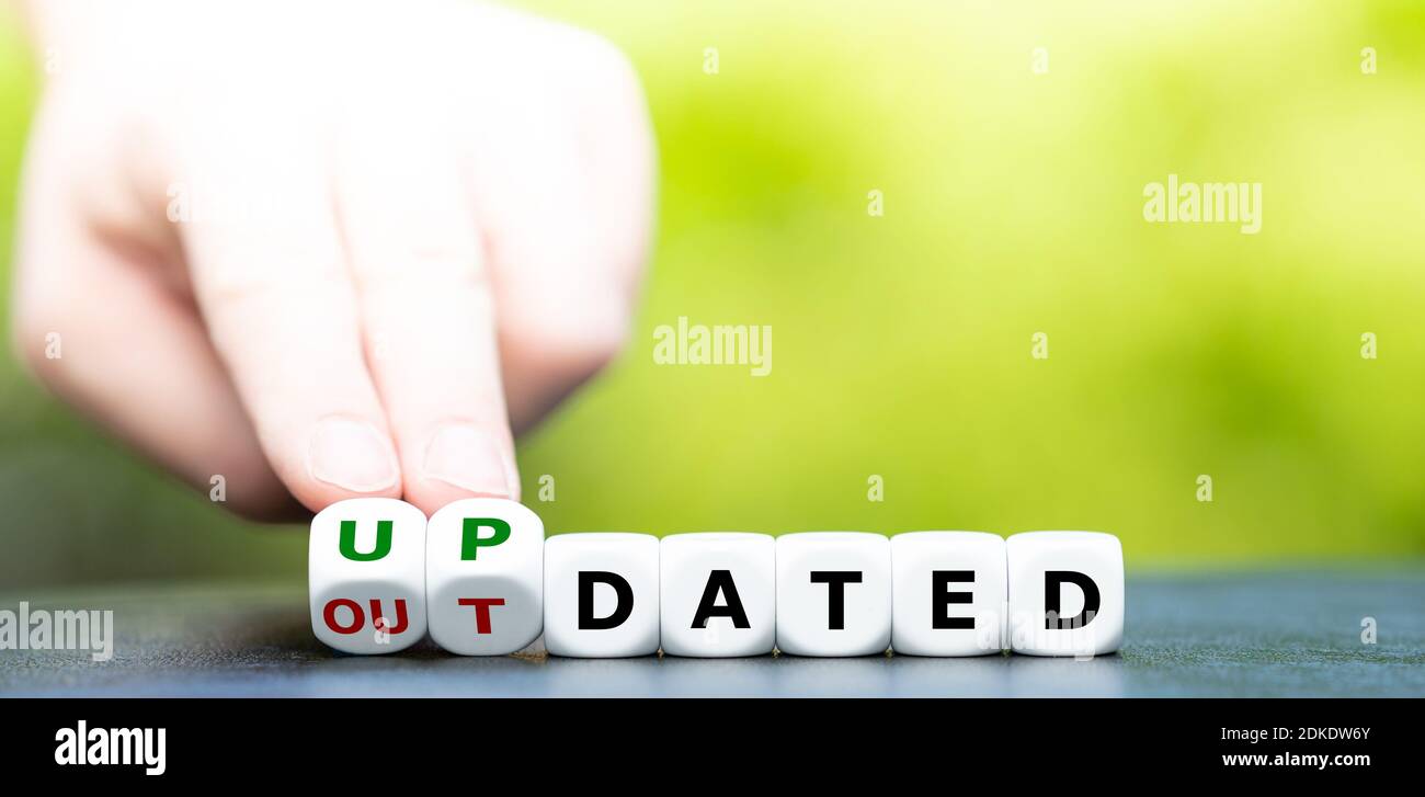 Hand Turns Dice And Changes The Word Outdated To Updated Stock Photo Alamy