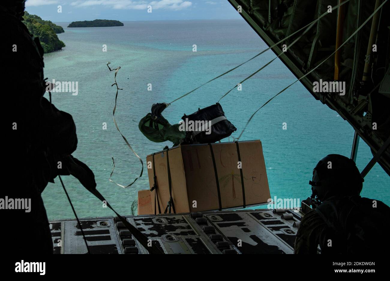 Bundles of donated goods are airdropped into shallow water during Operation Christmas Drop 2020 December 7, 2020 onto Koror, Republic of Palau. Operation Christmas is the longest-running humanitarian airlift operation begun in 1952 to assist remote islanders scattered across 50 islands in the Pacific. Stock Photo