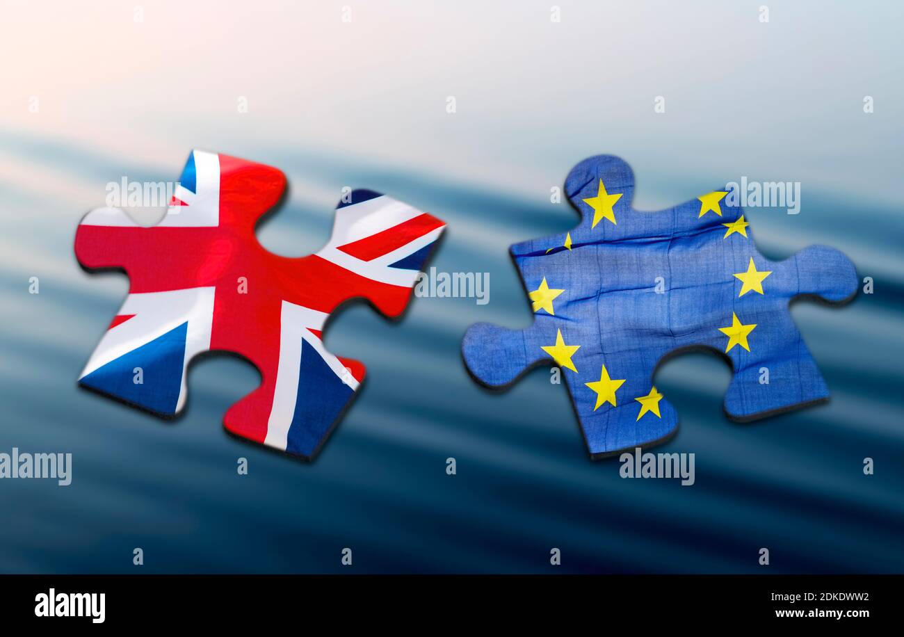 Two puzzle pieces with the flags of Great Britain and Europe on a blue ...