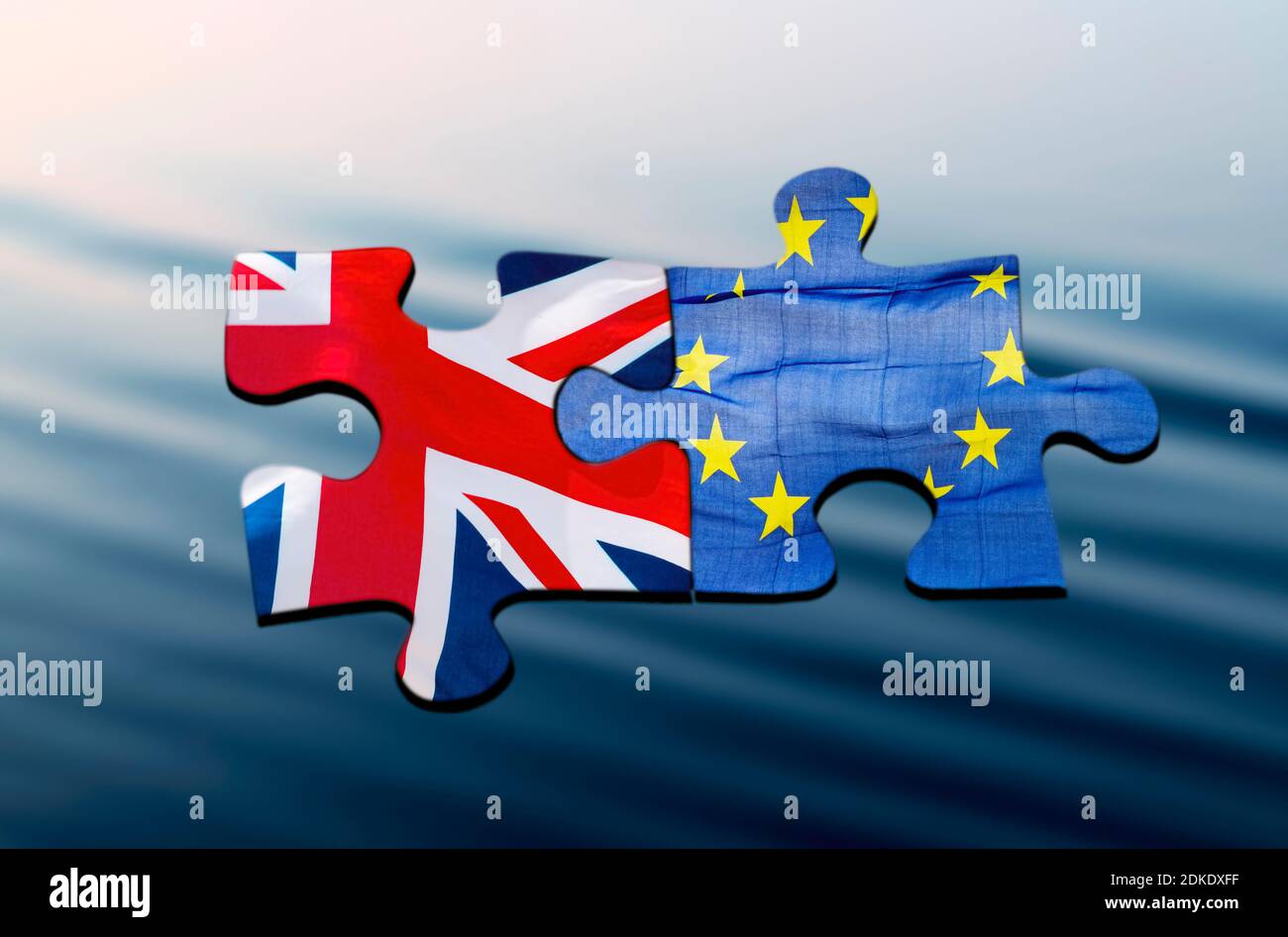 Two puzzle pieces with the flags of Great Britain and Europe on a blue ...