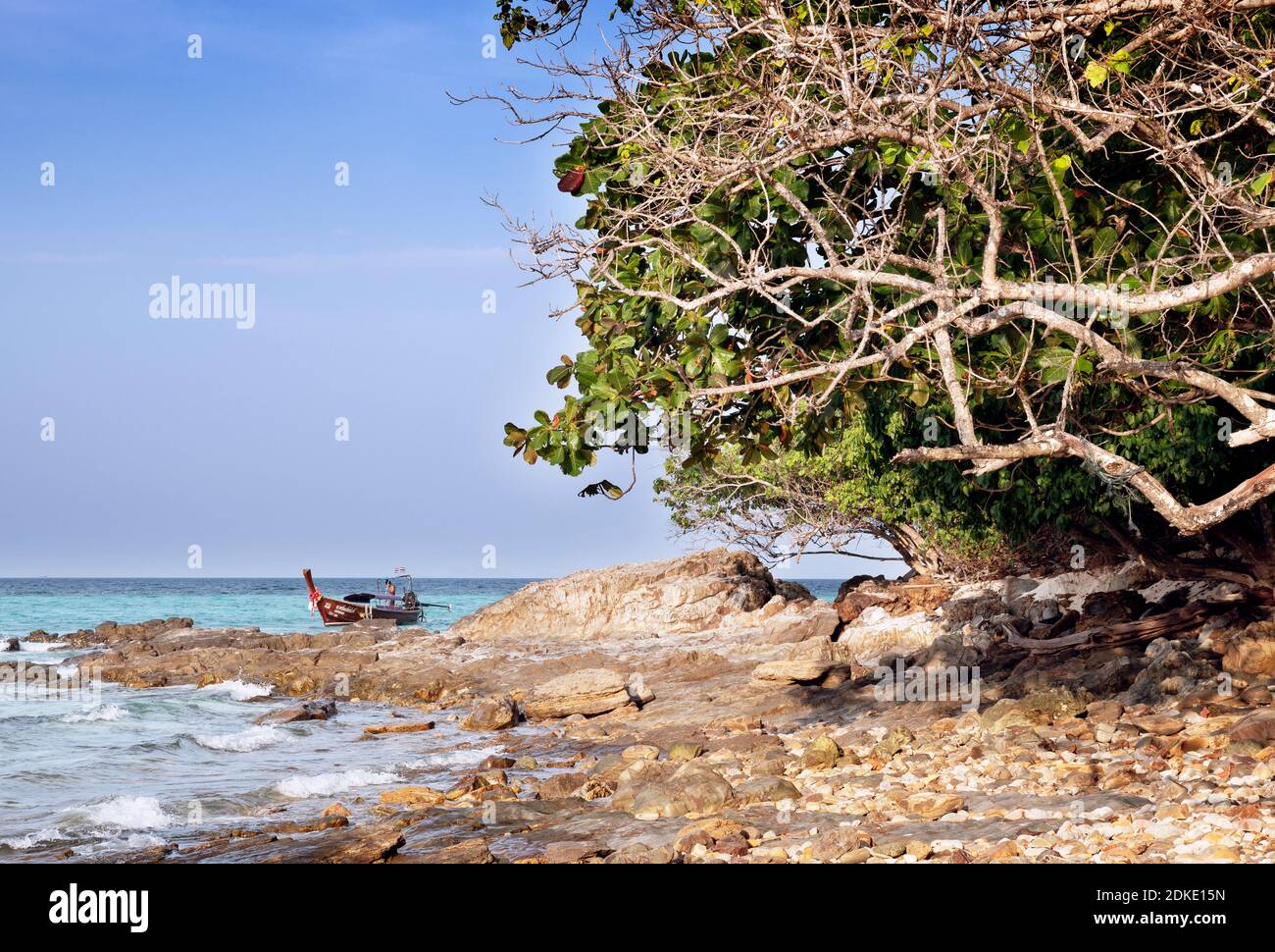 A longtail boat anchors off the uninhabited Bamboo Island off the Phi Phi Islands, Thailand Stock Photo