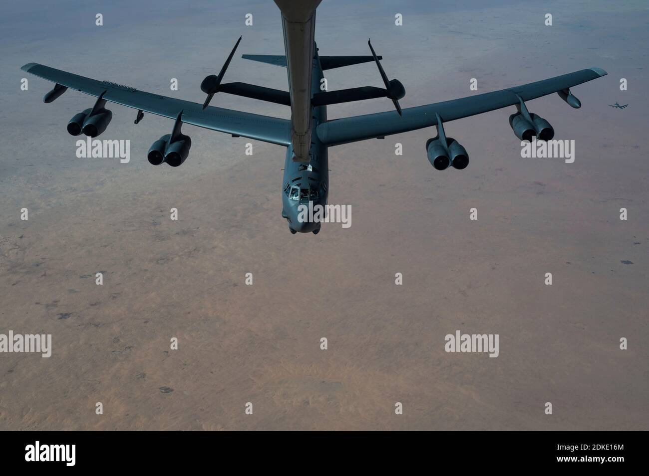 A U.S. Air Force B-52 Stratofortress strategic bomber aircraft from the 2nd Bomb Wing, is refueled inflight from a KC-135 Stratotanker aircraft during a multi-day Bomber Task Force mission December 10, 2020 over Qatar. The bomber was relocated to the region following an increase in tensions with Iran. Stock Photo