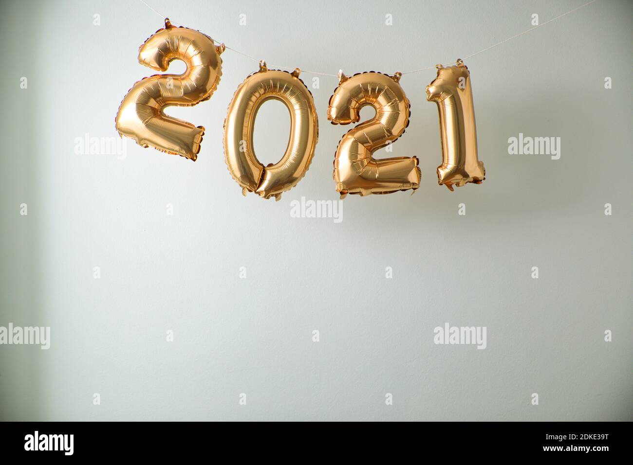 2021 inflated balloon numbers on white indoor background. Stock Photo
