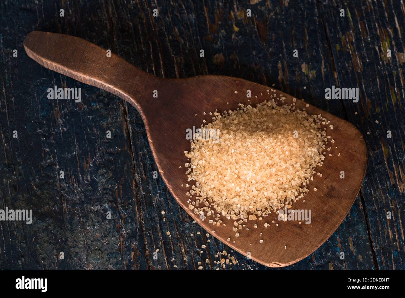 Close-up Of Sugar In Wooden Spoon On Table Stock Photo