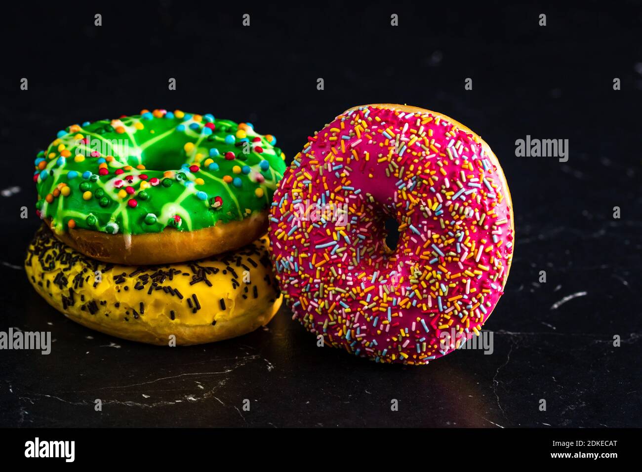 Glazed donuts with sprinkles isolated. Close up of colorful donuts ...