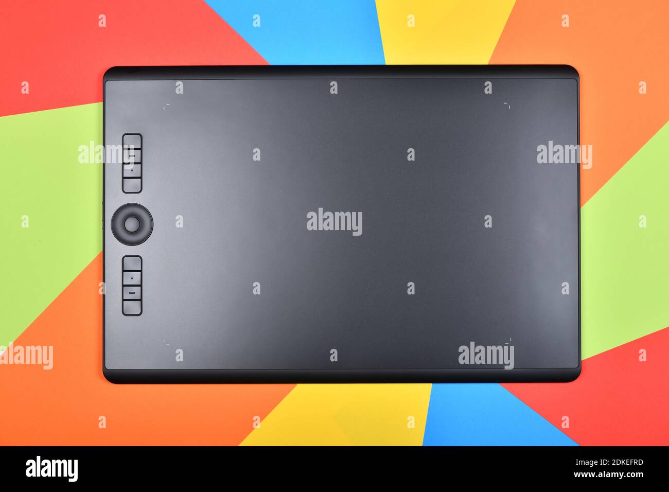 Top view professional graphics tablet. Isolated on multicolored background. High resolution photo. Full depth of field. Stock Photo