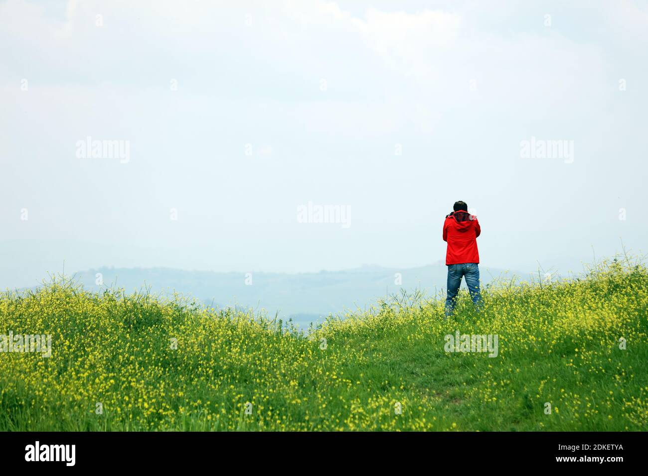 Man Standing On Field Against Sky Stock Photo