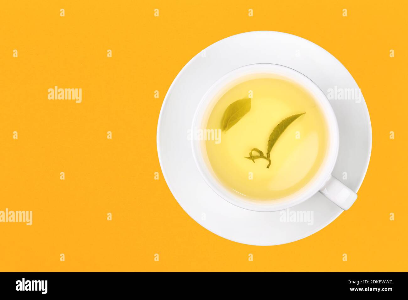 Directly Above Shot Of Herbal Tea On Yellow Background Stock Photo