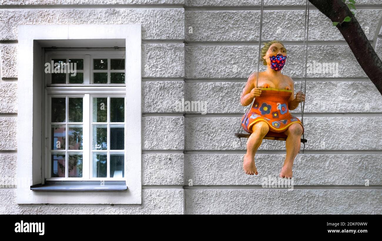 Sculpture of a woman with face mask in Munich in autumn. Stock Photo