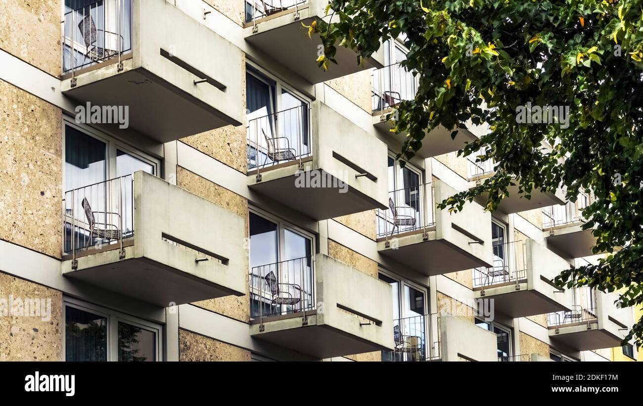 Repetitive small balconies with chairs in Munich Stock Photo