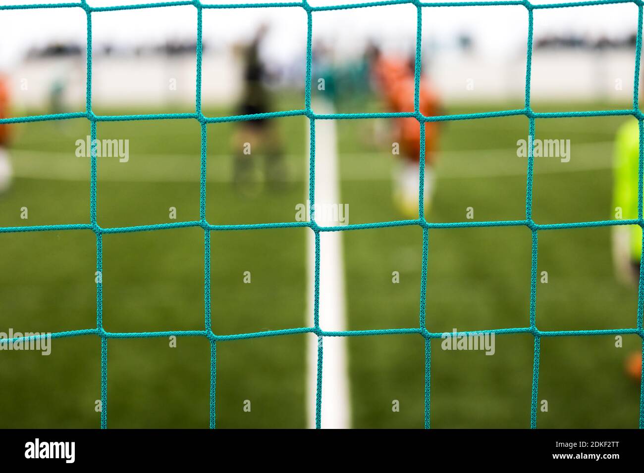 Soccer Field Through Goal Net Green Soccer Goal Net Blurred Football Stadum In The Background Stock Photo Alamy