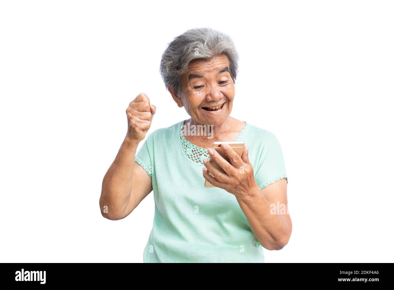 Smiling Senior Woman Taking Selfie Against White Background Stock Photo