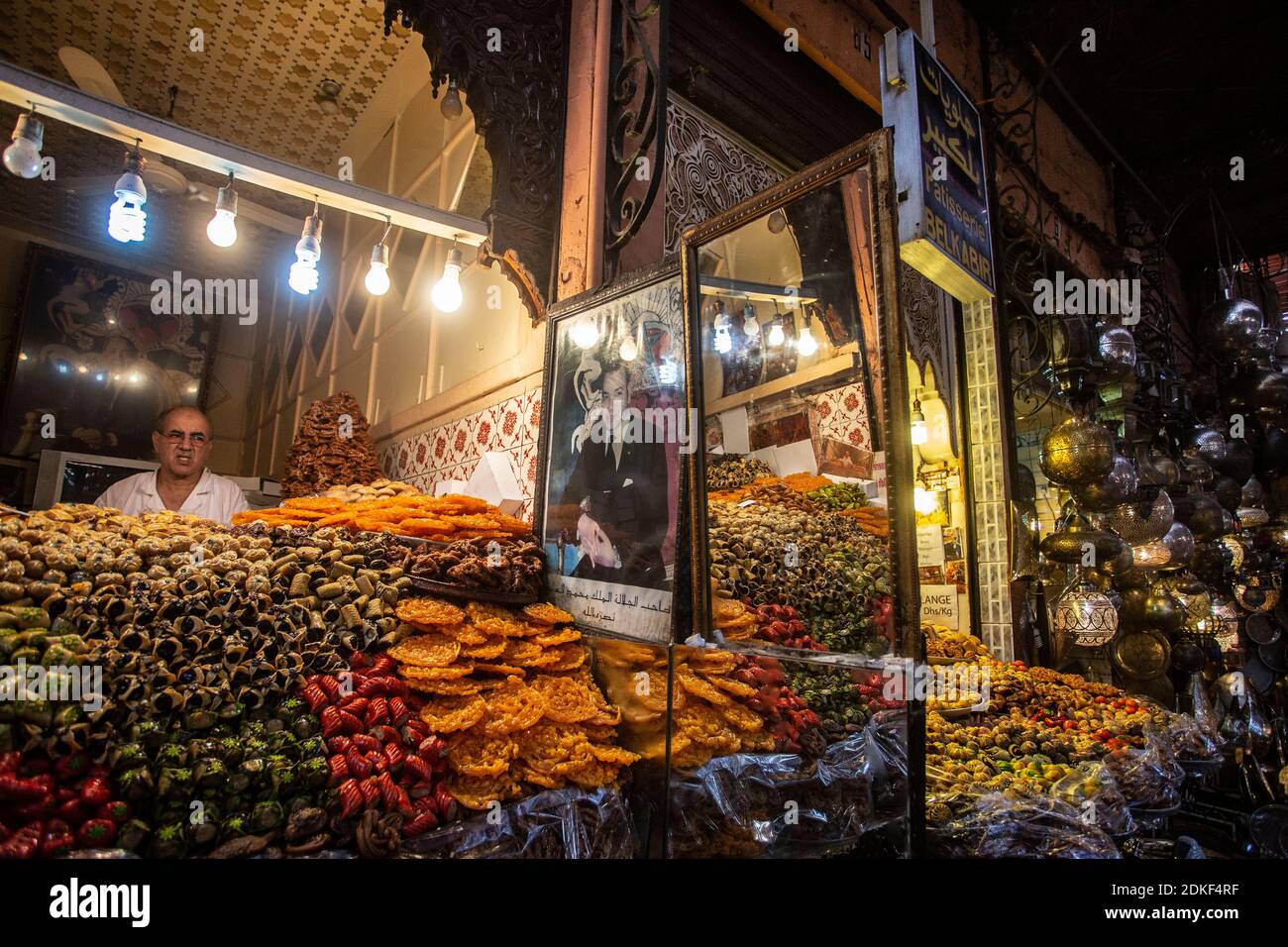 a seller in his shop inside the old Medina of Marrakech Stock Photo