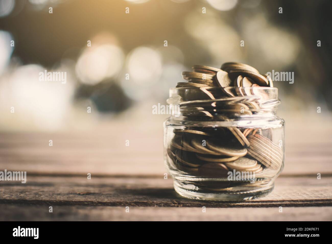Close-up Of Coins In Glass Jar On Table Stock Photo