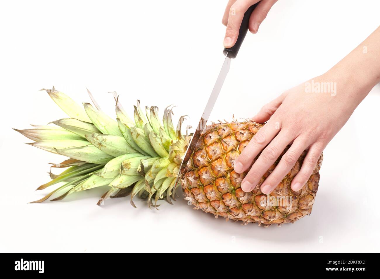 Cutting pineapple with knife on white background Stock Photo Alamy
