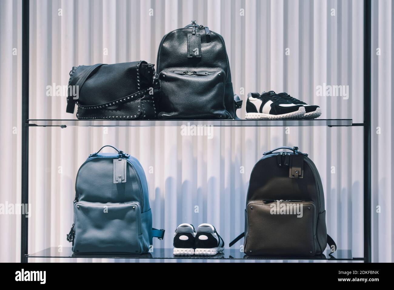 Elegant backpacks in a store - shopping concept Stock Photo - Alamy
