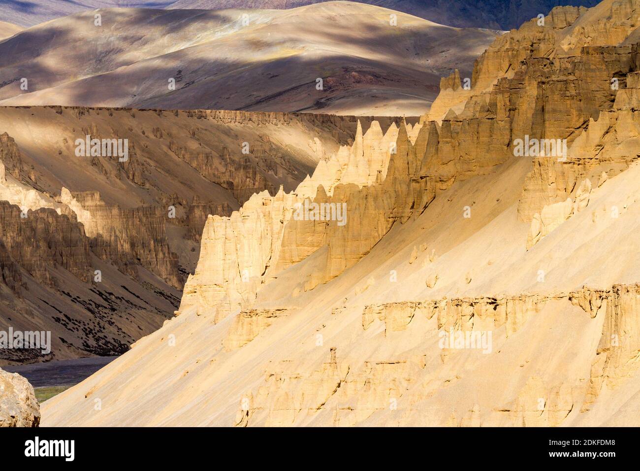 Fantastic natural sculptures - the result of erosion of sandstone mountains on the slope of a gorge in the Himalayas - and colorful play of light and Stock Photo