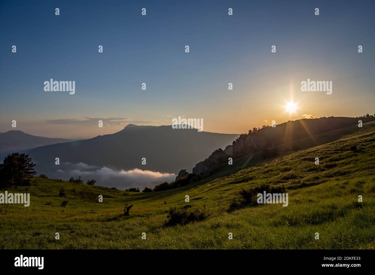 Scenic View Of Field Against Sky During Sunset Stock Photo