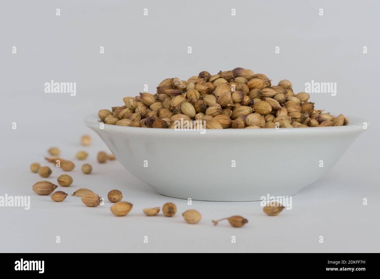 Seed In Bowl Against White Background Stock Photo