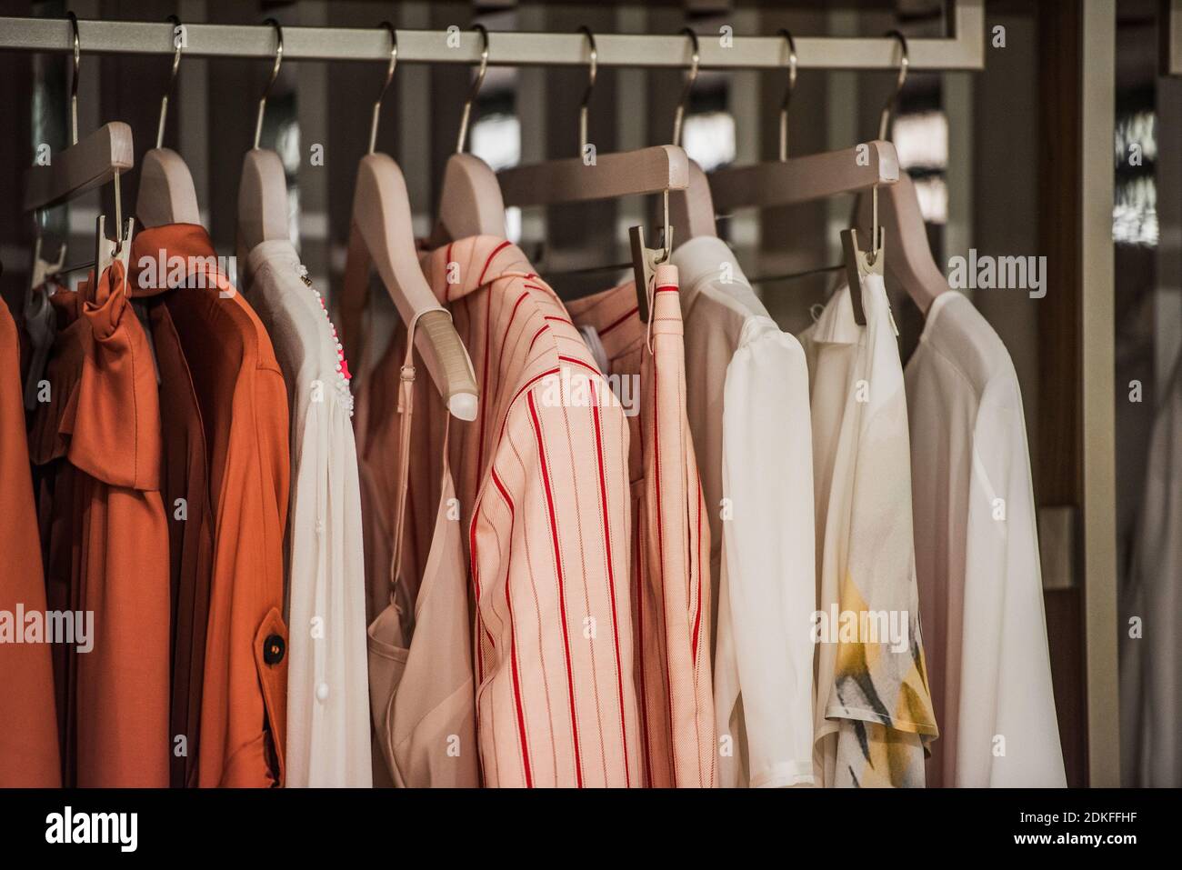 Women clothing on hangers in a mall - shopping in mall concept Stock Photo