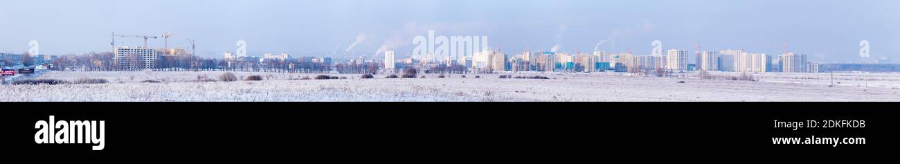 Panorama of new buildings and construction cranes in suburb in sunny cold winter day, Penza, Russia Stock Photo