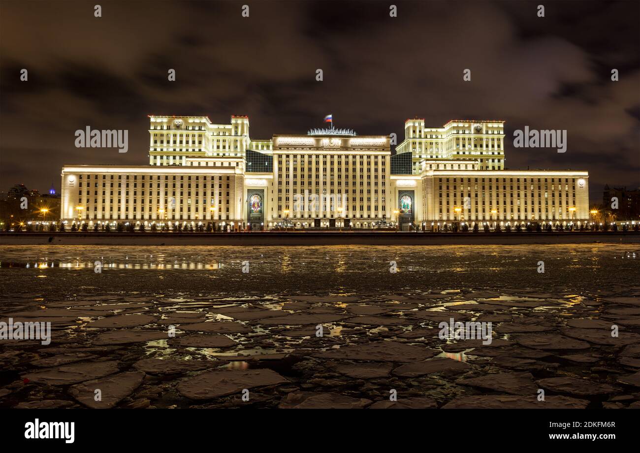 Russian Ministry of Defense in the evening in winter on a background of cloudy sky. On the foreground is Moscow River covered by ice floes. Stock Photo