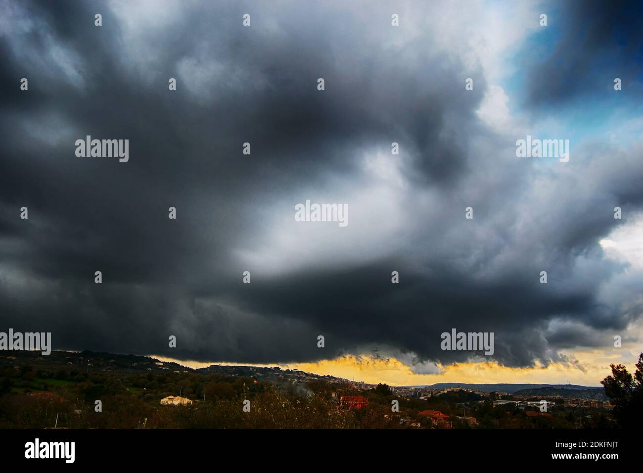 Light in the dark and dramatic storm clouds background. Storm clouds. Supercell Storm Cumulonimbus Stock Photo