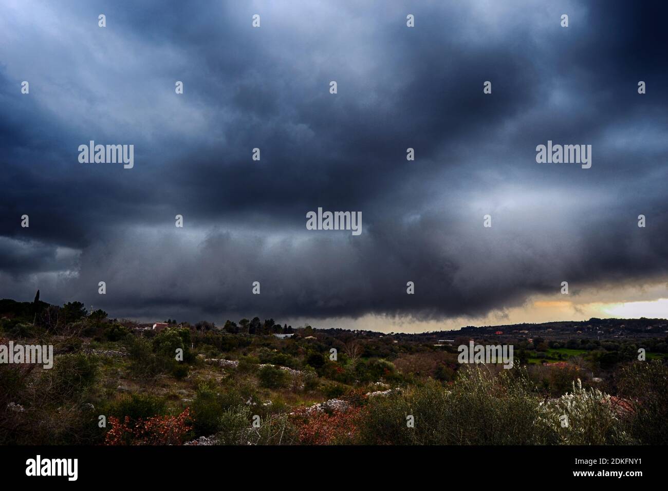 Light in the dark and dramatic storm clouds background. Storm clouds. Supercell Storm Cumulonimbus Stock Photo