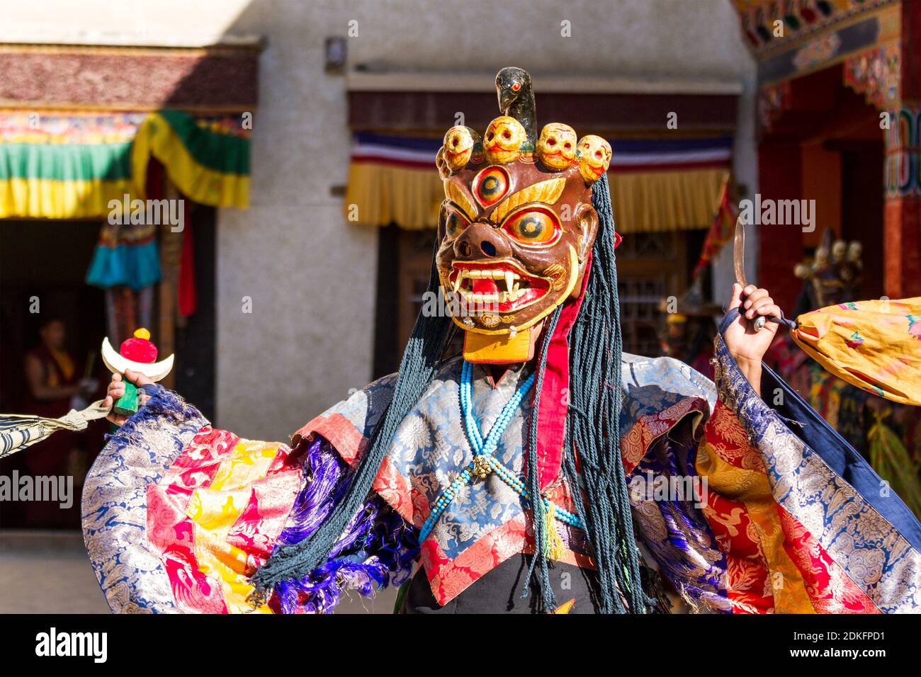 Unidentified monk in mask performs a religious masked and costumed mystery dance of Tibetan Buddhism during the Cham Dance Festival in monast Stock Photo -