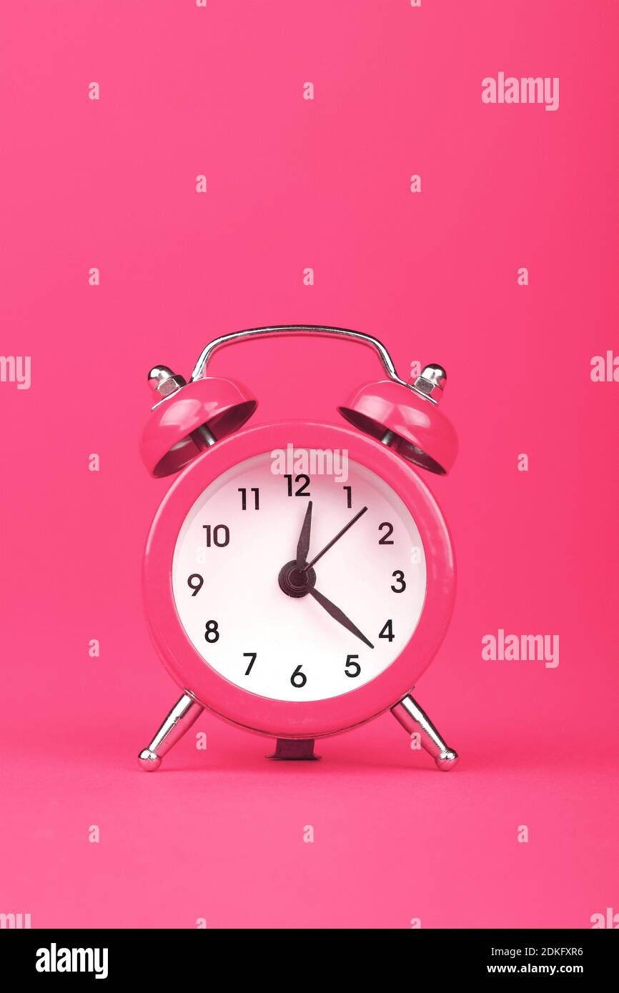 Close-up Of Alarm Clock Against Pink Background Stock Photo