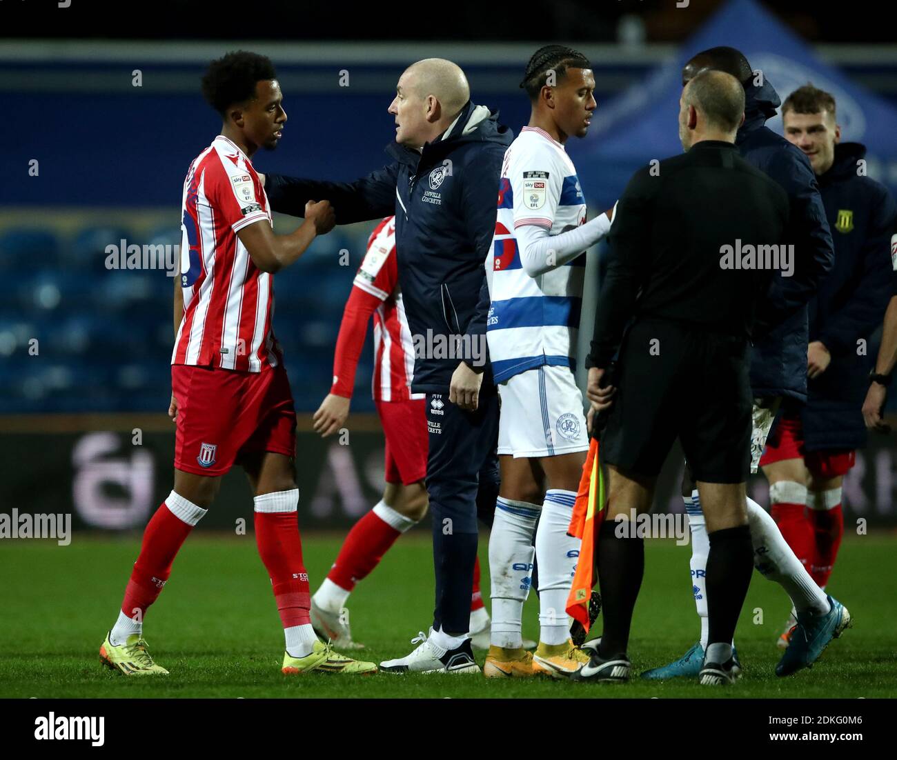 Stoke City's Tashan Oakley-Boothe (left) is greeted by Queens Park Rangers manager Mark Warburton as players from both teams shake hands on the pitch after the match, after the Sky Bet Championship match at the Kiyan Prince Foundation Stadium, London. Stock Photo