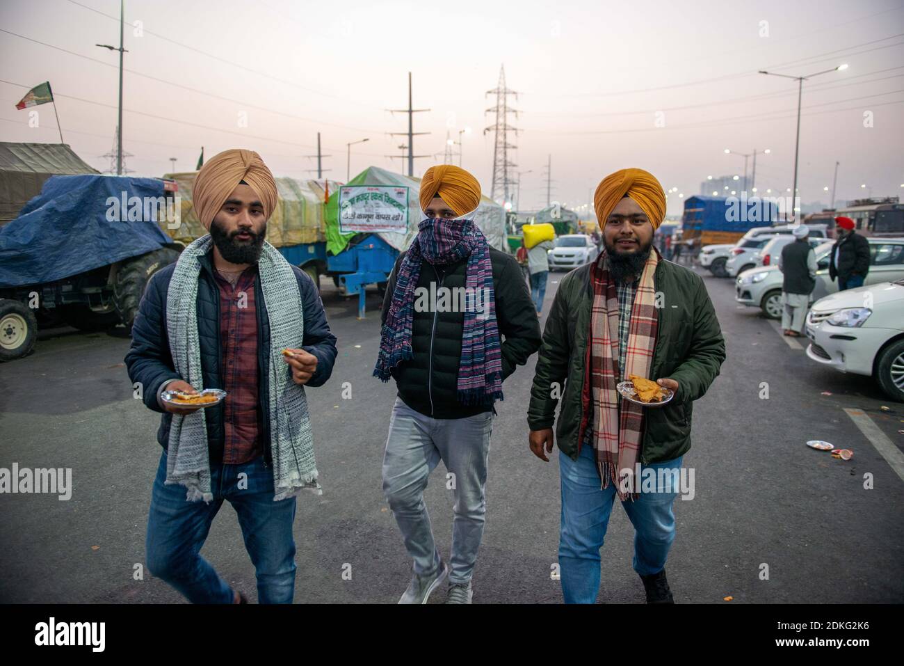Sikh protesters wearing jackets and woollen stoles to wave off the cold weather during the demonstration.Farmers continue to protest at Delhi-Meerut Expressway and threaten to completely block another highway that connects to Delhi. Farmers want the three legislations to be scrapped while the government asserts that it is willing to continue talks but won't take back the laws. Stock Photo