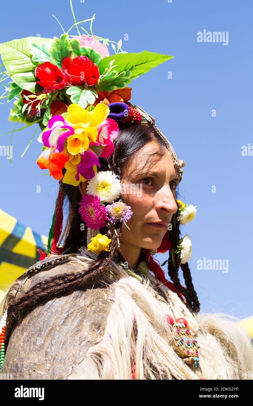 Leh, Jammu and Kashmir, India - Sep 01, 2012: The woman of Dard ethnic group in traditional clothing with the familiar headgear in the processing on t Stock Photo