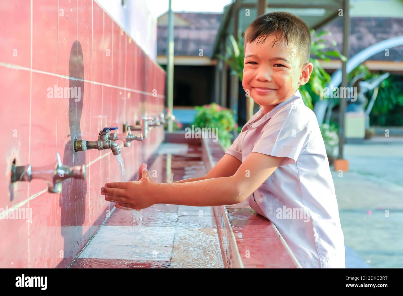 Soft focus, Health care and kid concept. Asian child boy washing his hands before eating food and after play the toys at the washing bowl. A boy aged of 5-6 years old. Stock Photo