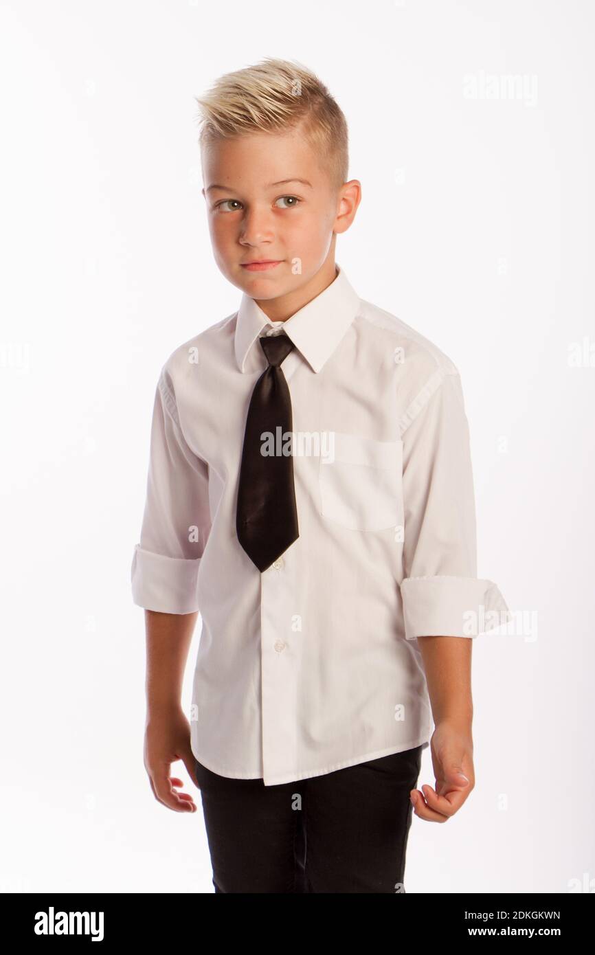 Studio portrait of stylish caucasian blond boy in shirt and tie, white background, copy space Stock Photo